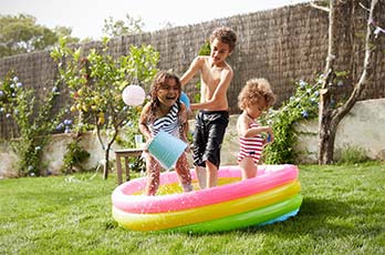 Children splashing in paddling pool