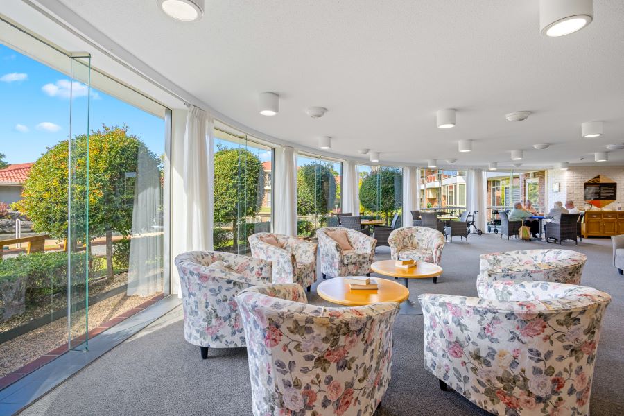 Cafe area surrounded by ceiling high windows