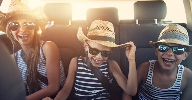 Kids laughing in the backseat of a car