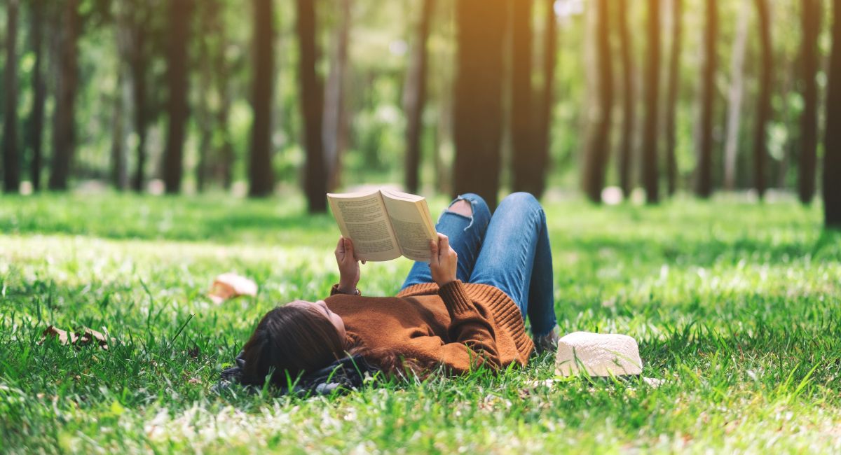 A young woman reading in a park