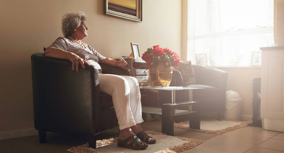 An elderly women sitting alone