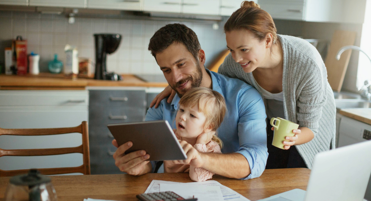 Parents with a  young child doing bills