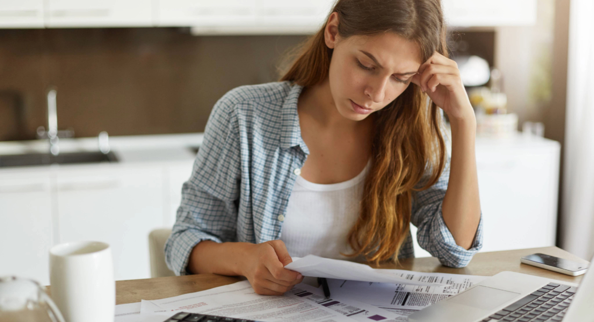 A young woman stressing over bills