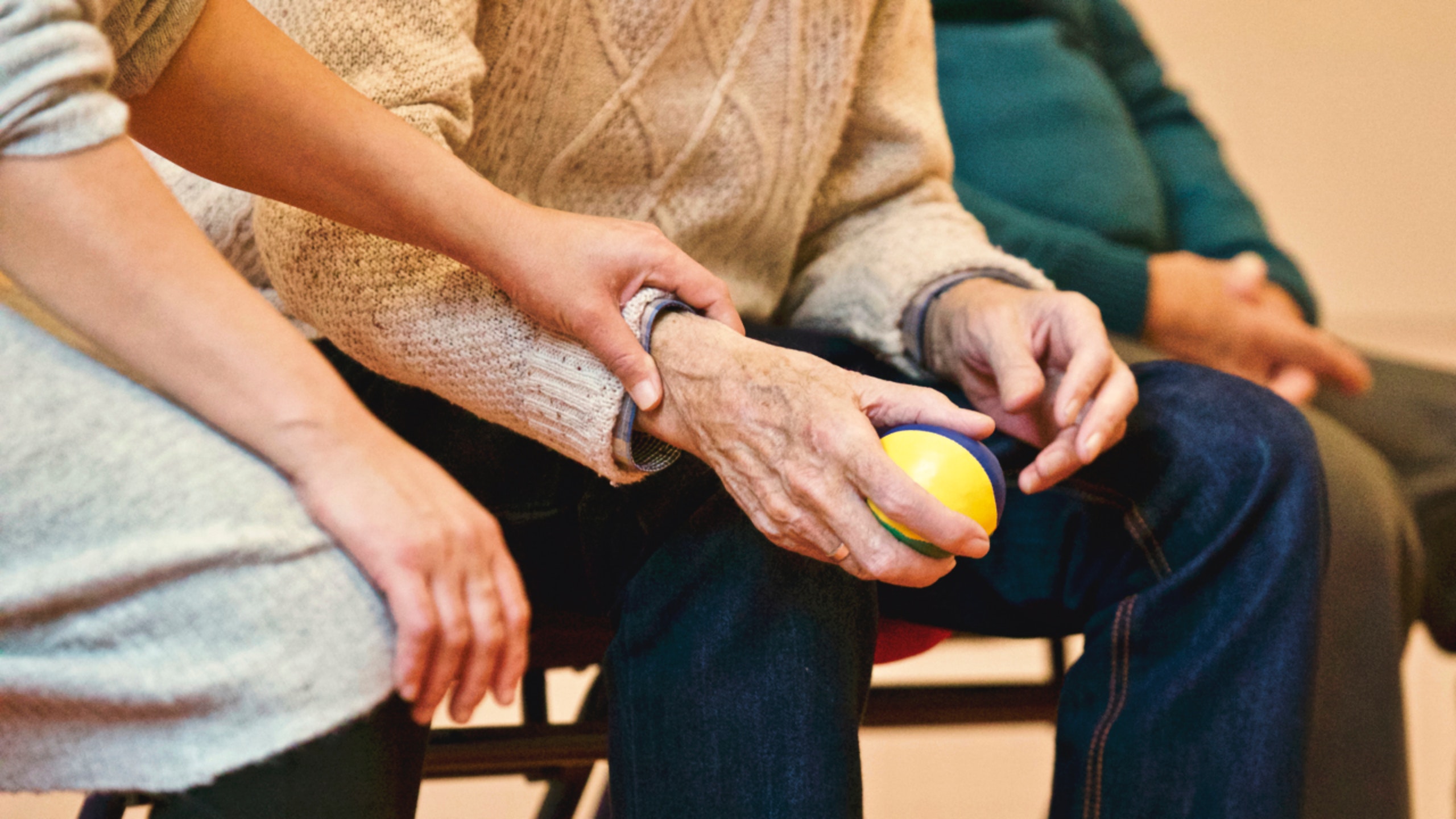 Close up of care worker helping elderly patient